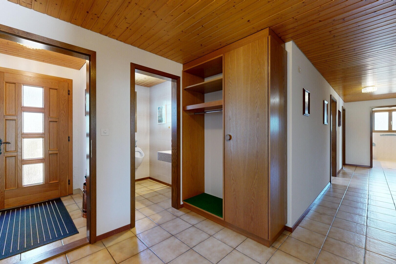 corridor with wood ceiling and light tile patterned flooring