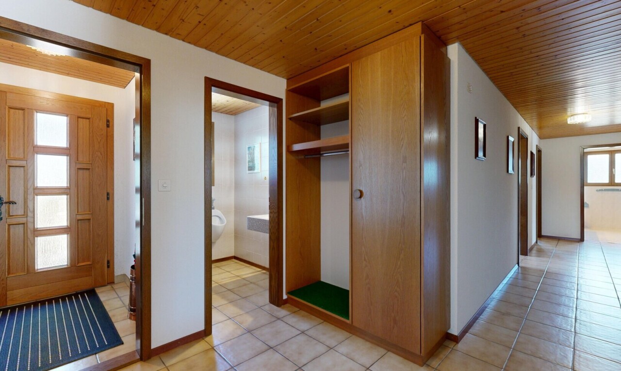 corridor with wood ceiling and light tile patterned flooring
