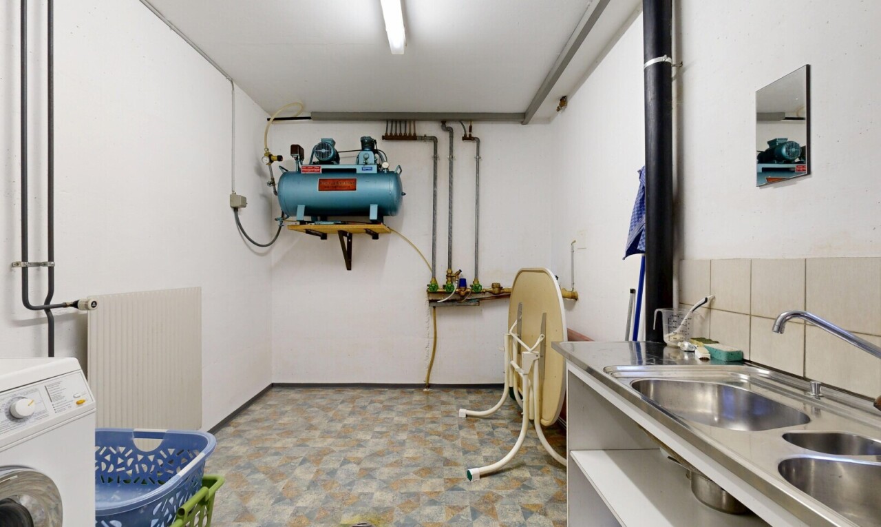 laundry area featuring washer / clothes dryer and radiator heating unit