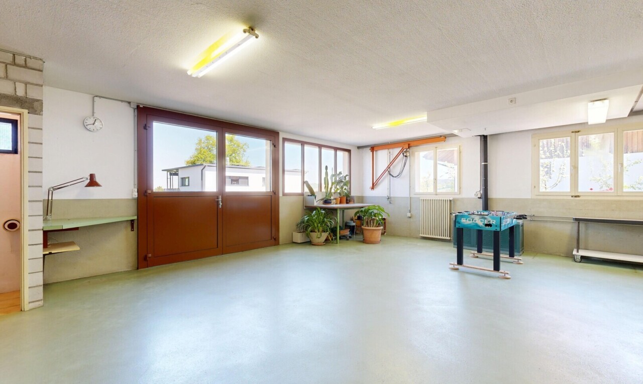 unfurnished room with healthy amount of natural light, concrete flooring, radiator, and a textured ceiling