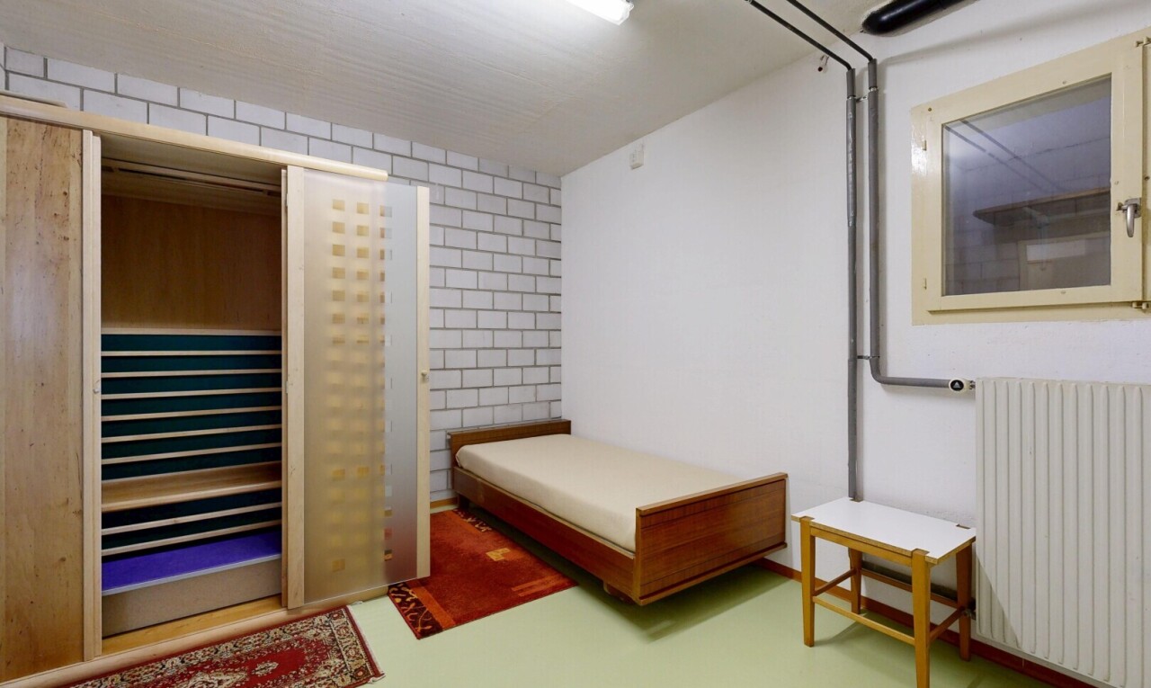 room with radiator heating unit and concrete floors