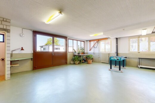 unfurnished room with healthy amount of natural light, concrete flooring, radiator, and a textured ceiling