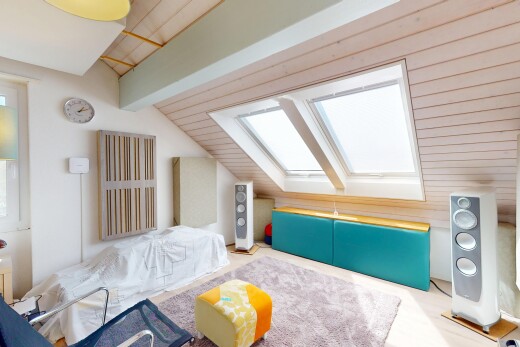 salon avec plafond voûté, cloison sèche, puits de lumière, pièce supplémentaire, et plafond à poutres