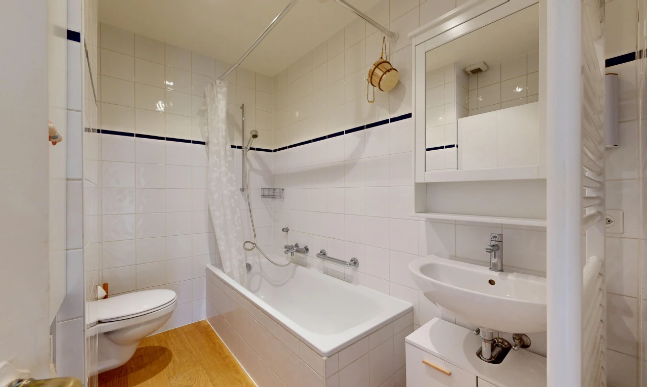 salle de bains avec miroir, mur en carrelage, tile wall, douche-bain combinés, et toilette