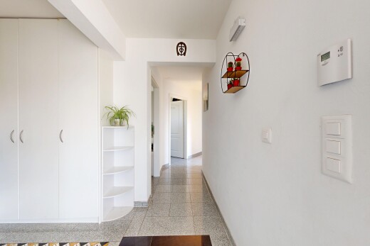 hall featuring baseboards and granite floors