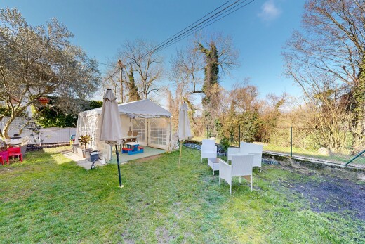 garden with a fenced backyard and a patio area