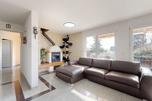 living area featuring baseboards and a wood stove