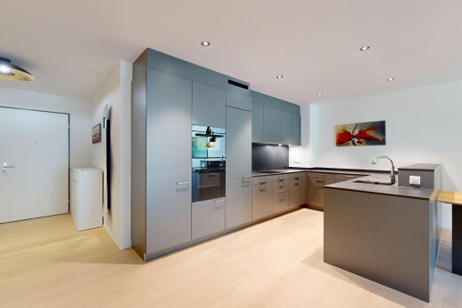 kitchen featuring recessed lighting, a peninsula, modern cabinets, dark countertops, and light wood-style floors