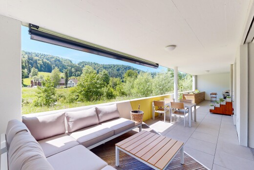 patio / terrace featuring a patio area, an outdoor living / dining area, and a wooded view