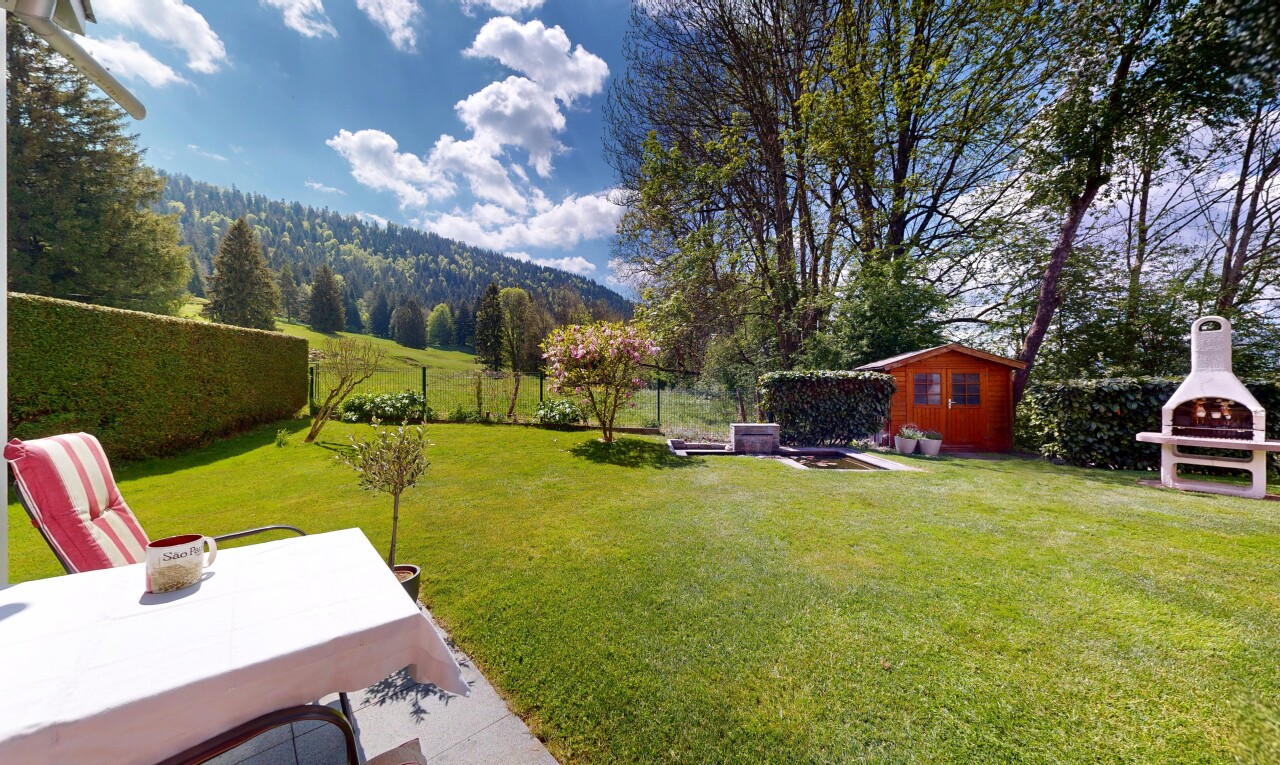 garden with a fenced backyard and an outbuilding
