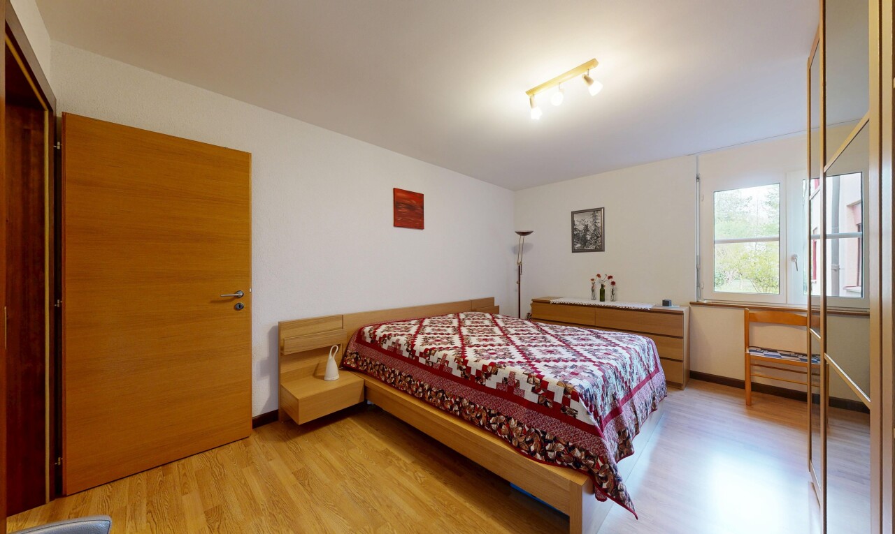 room with light wood finished floors and track lighting