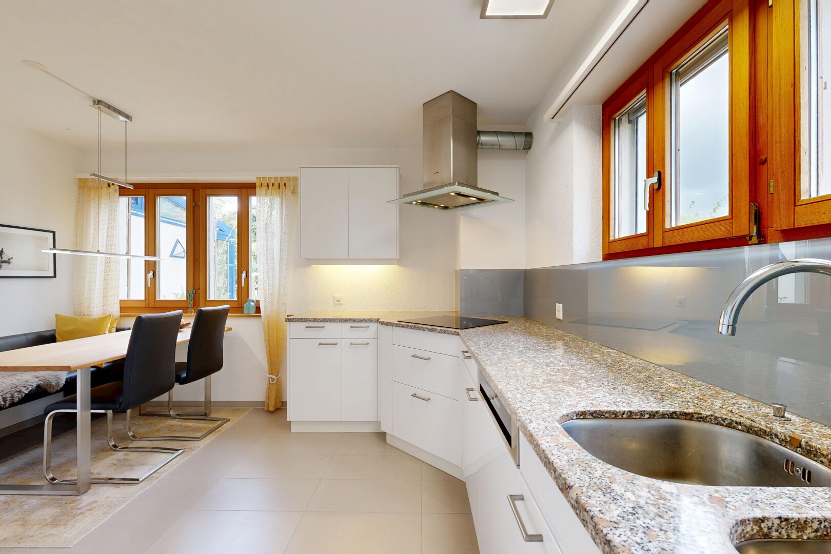 cuisine avec armoires blanches, white cabinets, évier, light floor, et hotte