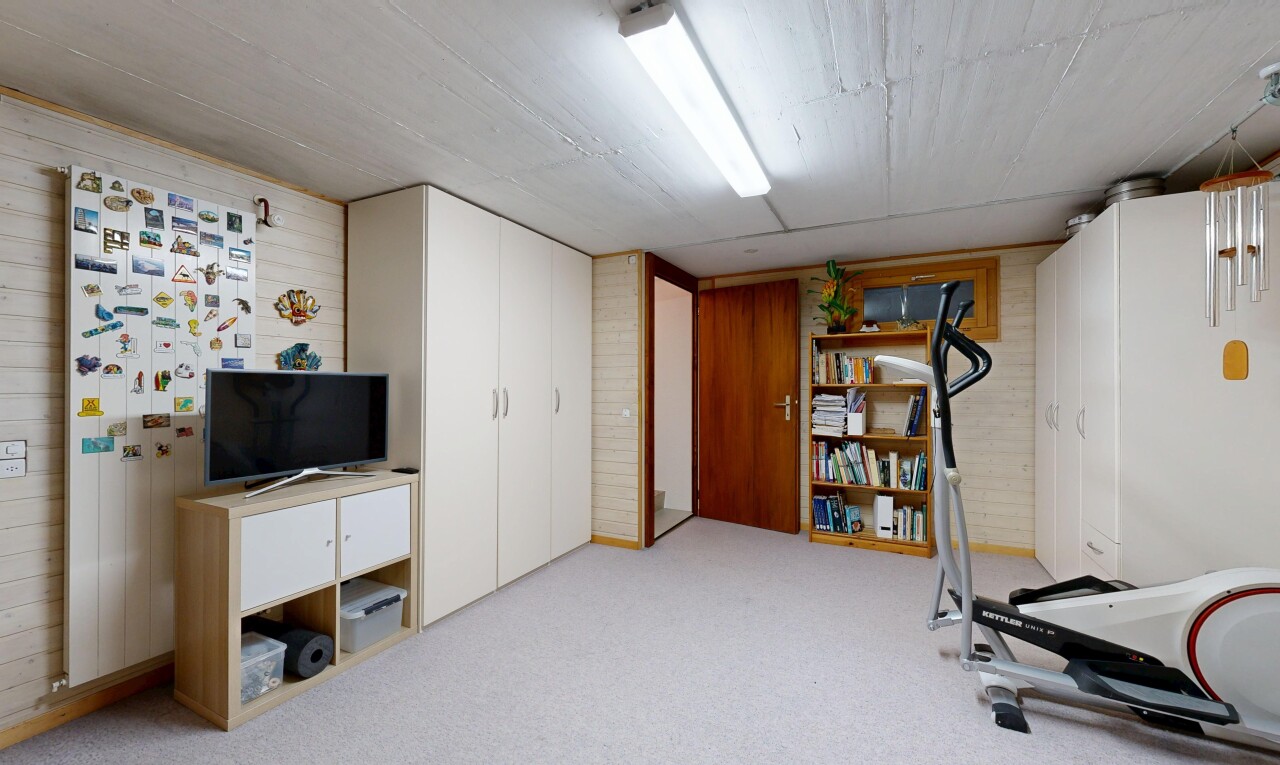 gym avec low ceiling, plafond bas, wood wall, mur en bois, et inside property