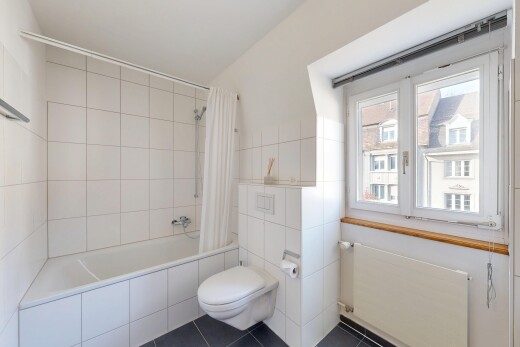 full bath with radiator heating unit, tiled shower / bath combo, tile walls, and dark tile patterned floors
