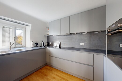 kitchen with gray cabinetry, light wood-type flooring, backsplash, open shelves, and modern cabinets