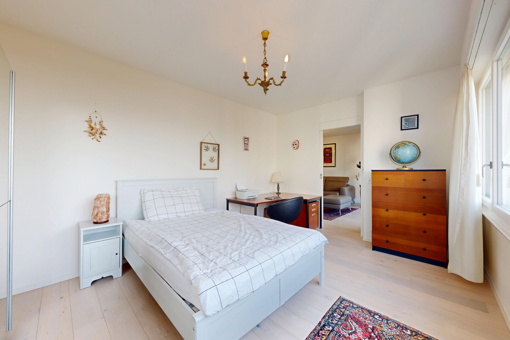 room with a chandelier and light wood-type flooring