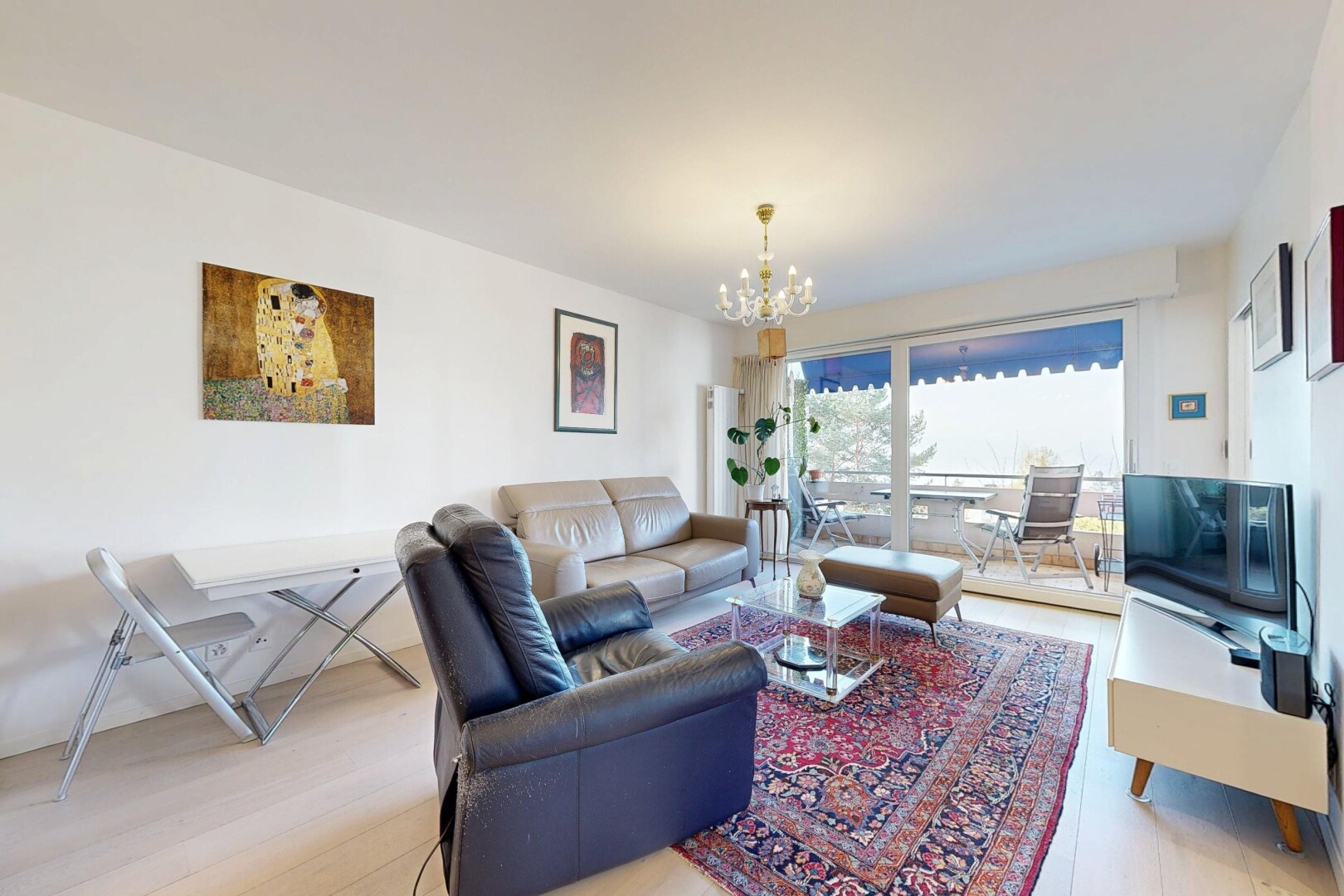 living room with light wood-type flooring and a chandelier