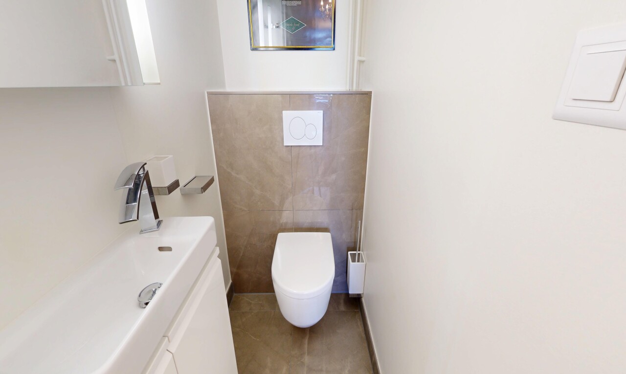 bathroom featuring vanity, light tile patterned floors, and tile walls