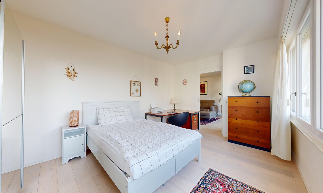 room with a chandelier and light wood-type flooring