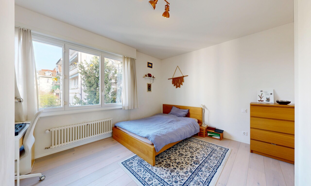 room / bedroom featuring radiator and light wood-style flooring