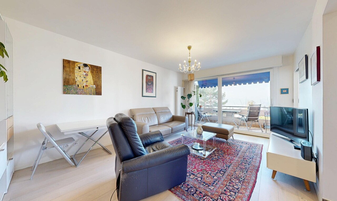 living room with light wood-type flooring and a chandelier