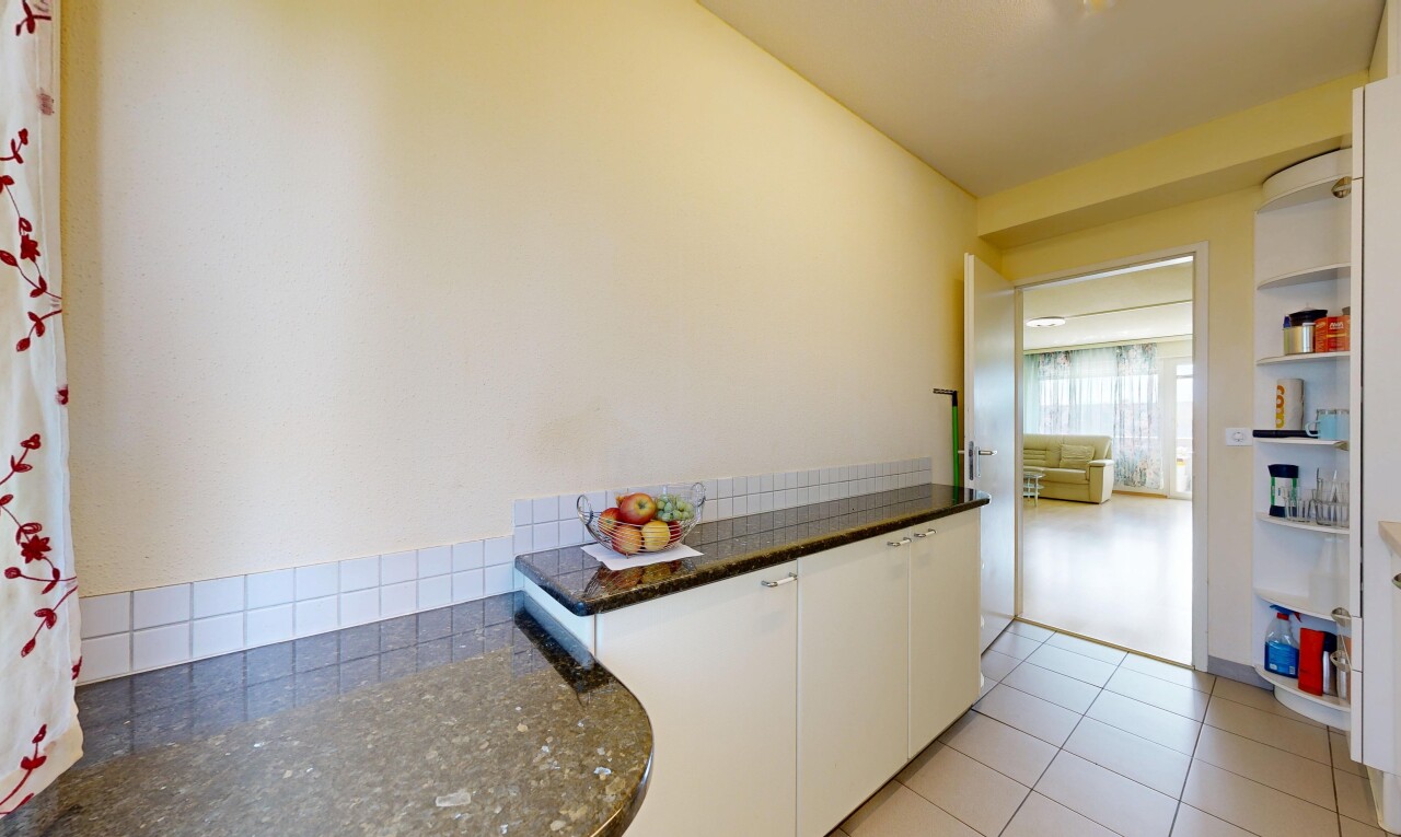 cuisine avec dark countertops, armoires blanches, white cabinets, inside property, et light floor