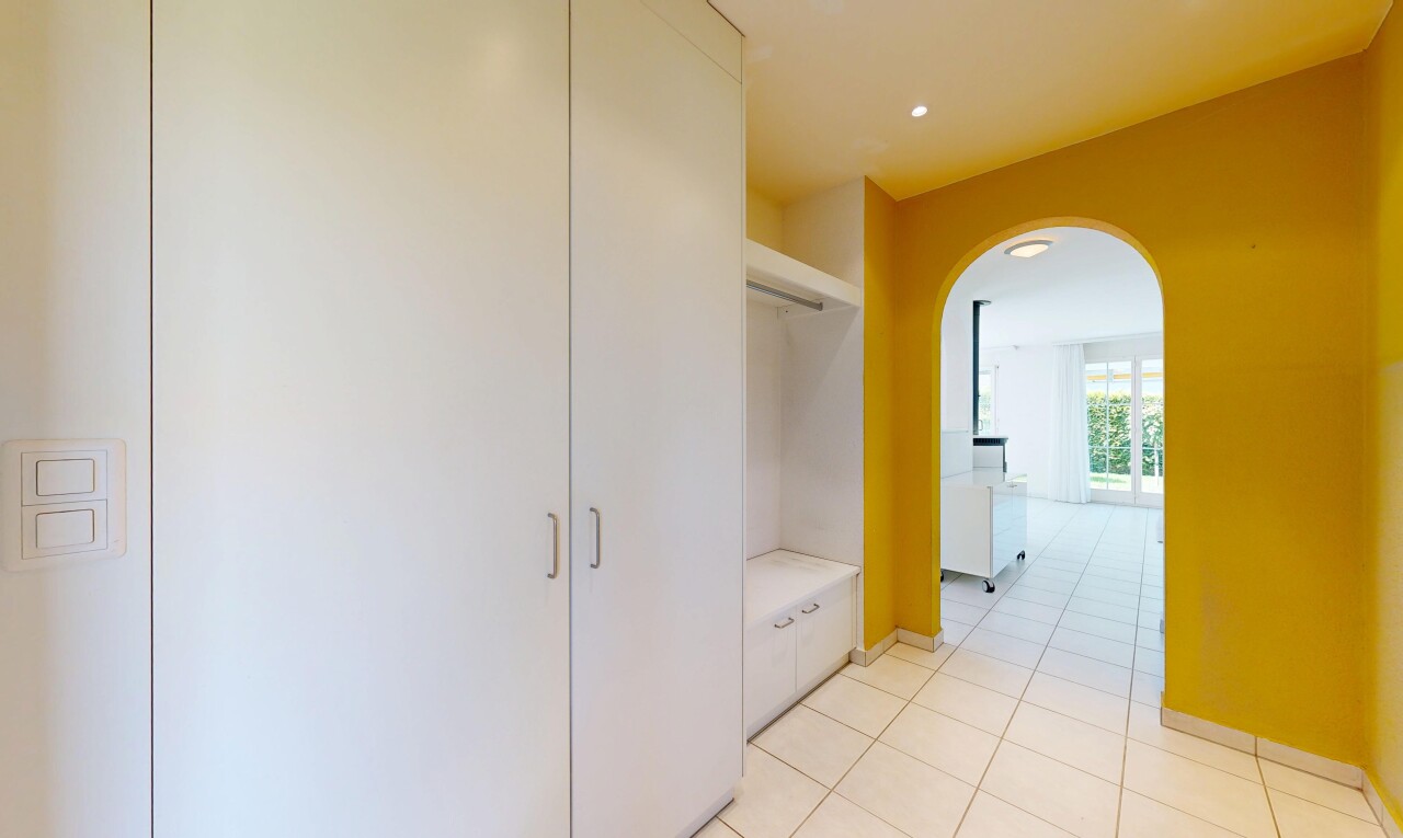 couloir avec light floor, drywall, cloison sèche, tile floor, et sol en carrelage