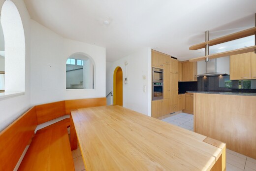 cuisine avec cloison sèche, drywall, armoires marron clair, light brown cabinets, et passages en arc