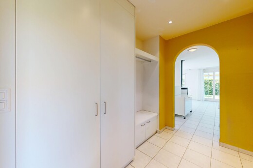 couloir avec light floor, drywall, cloison sèche, tile floor, et sol en carrelage