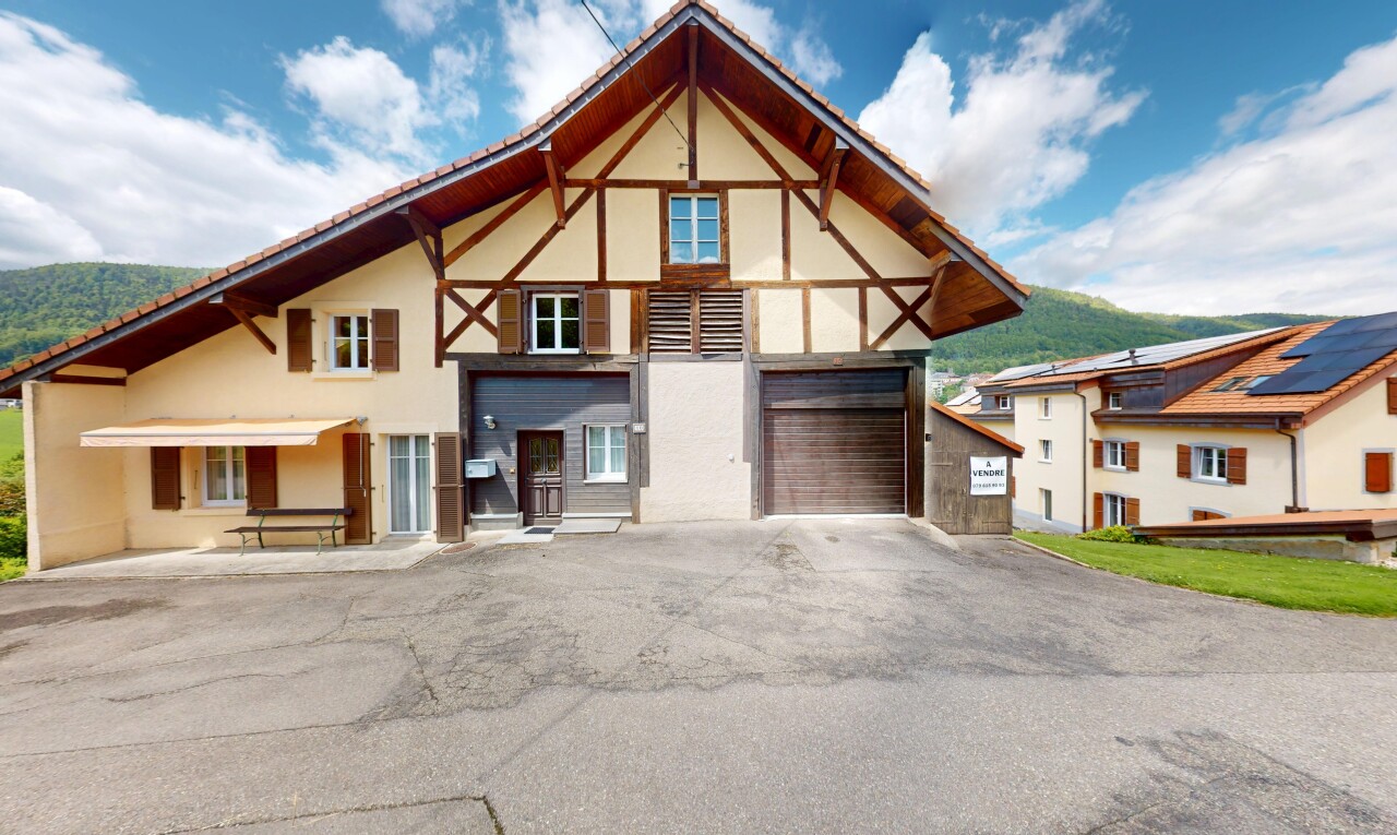 façade avec bardage en stuc, day time, property visible, allée, et garage intégré