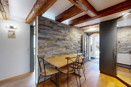 dining room with arched walkways, beamed ceiling, light wood-style floors, and recessed lighting