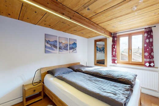 room featuring a wooden ceiling with exposed beams, radiator heating unit, and wood finished floors