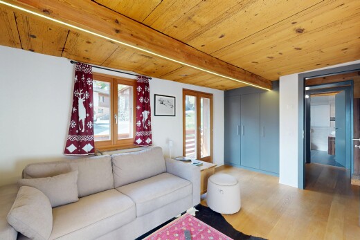 living area featuring a wooden ceiling with exposed beams and light wood-style floors