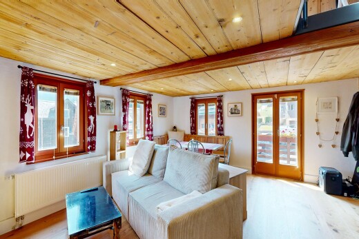 living area featuring radiator, a wooden ceiling with exposed beams, recessed lighting, and light wood-style flooring