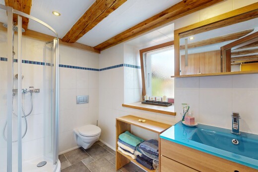 full bathroom with a stall shower, recessed lighting, beamed ceiling, vanity, and tile walls