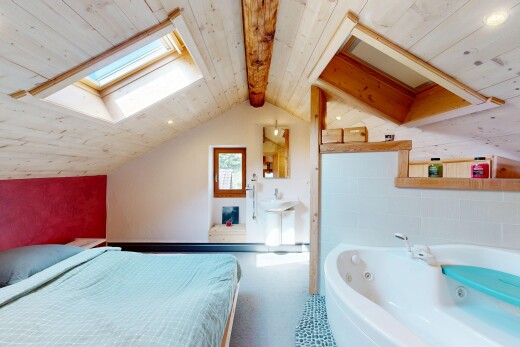 room with a skylight, a wood ceiling with exposed beams, and recessed lighting