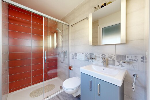 salle de bains avec lavabo (ou coiffeuse selon le contexte), miroir, mur en carrelage, tile wall, et salle de bain complète