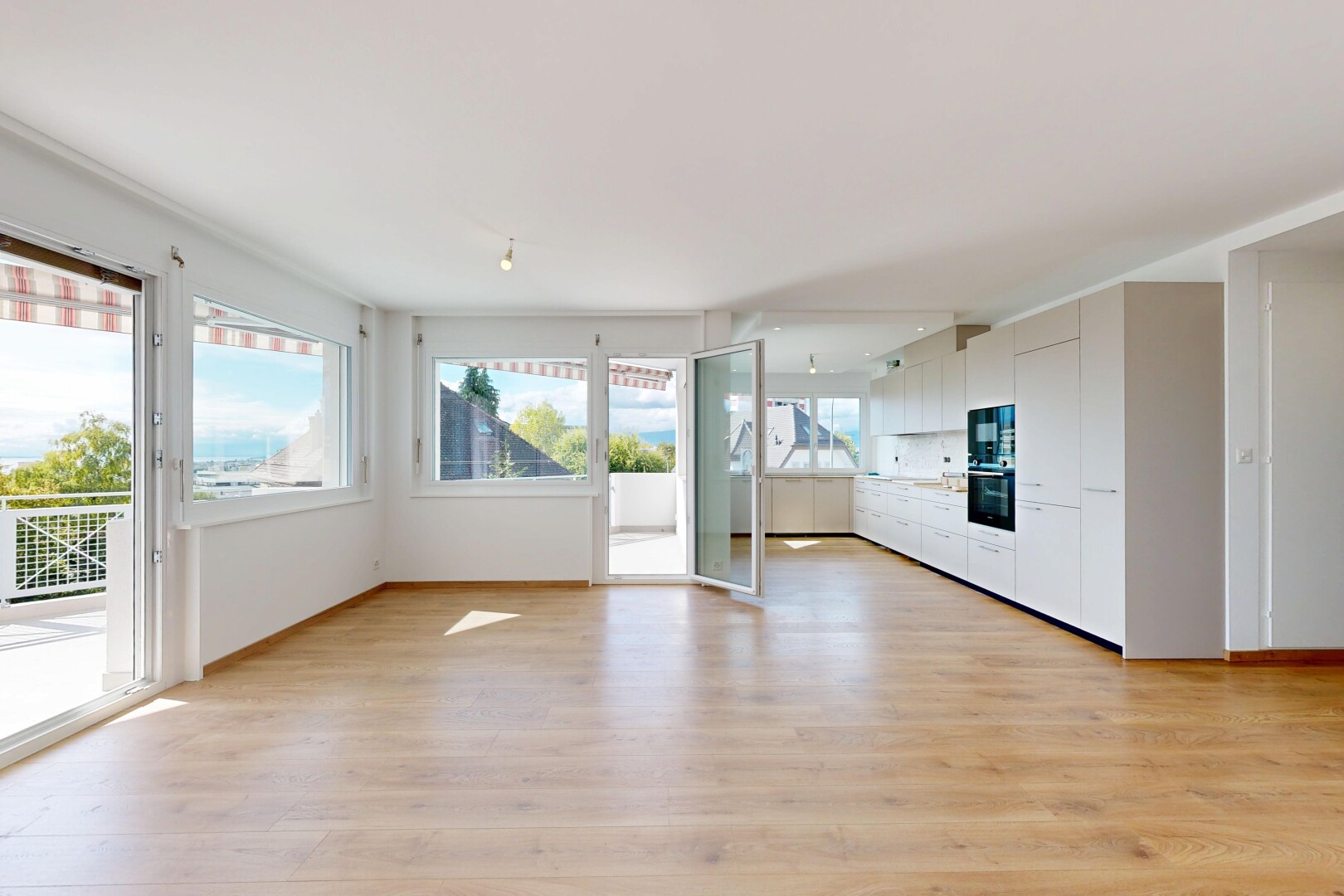 empty room featuring light wood-type flooring and baseboards