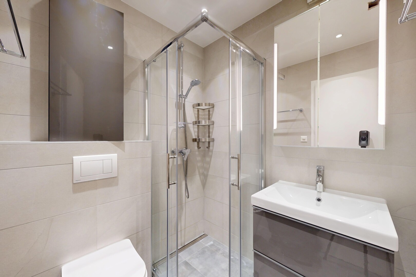 full bathroom with vanity, a stall shower, and tile walls