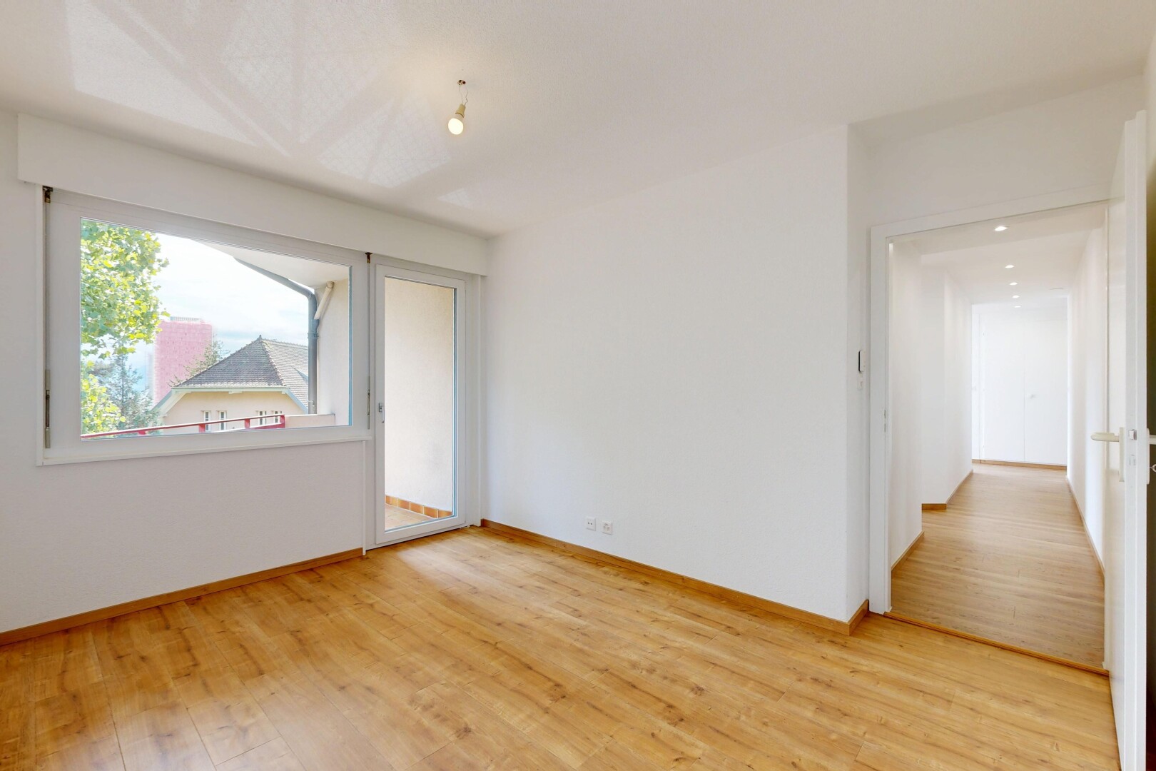 unfurnished room with light wood-style floors and baseboards