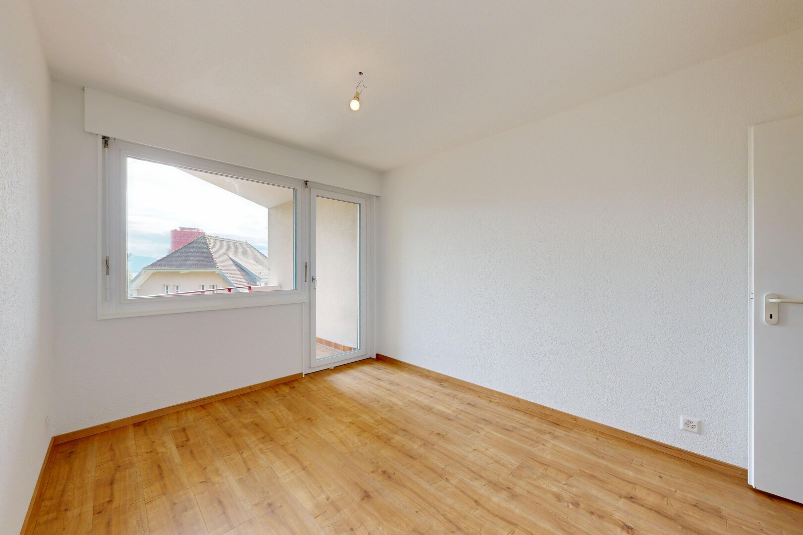 empty room with light wood finished floors and baseboards