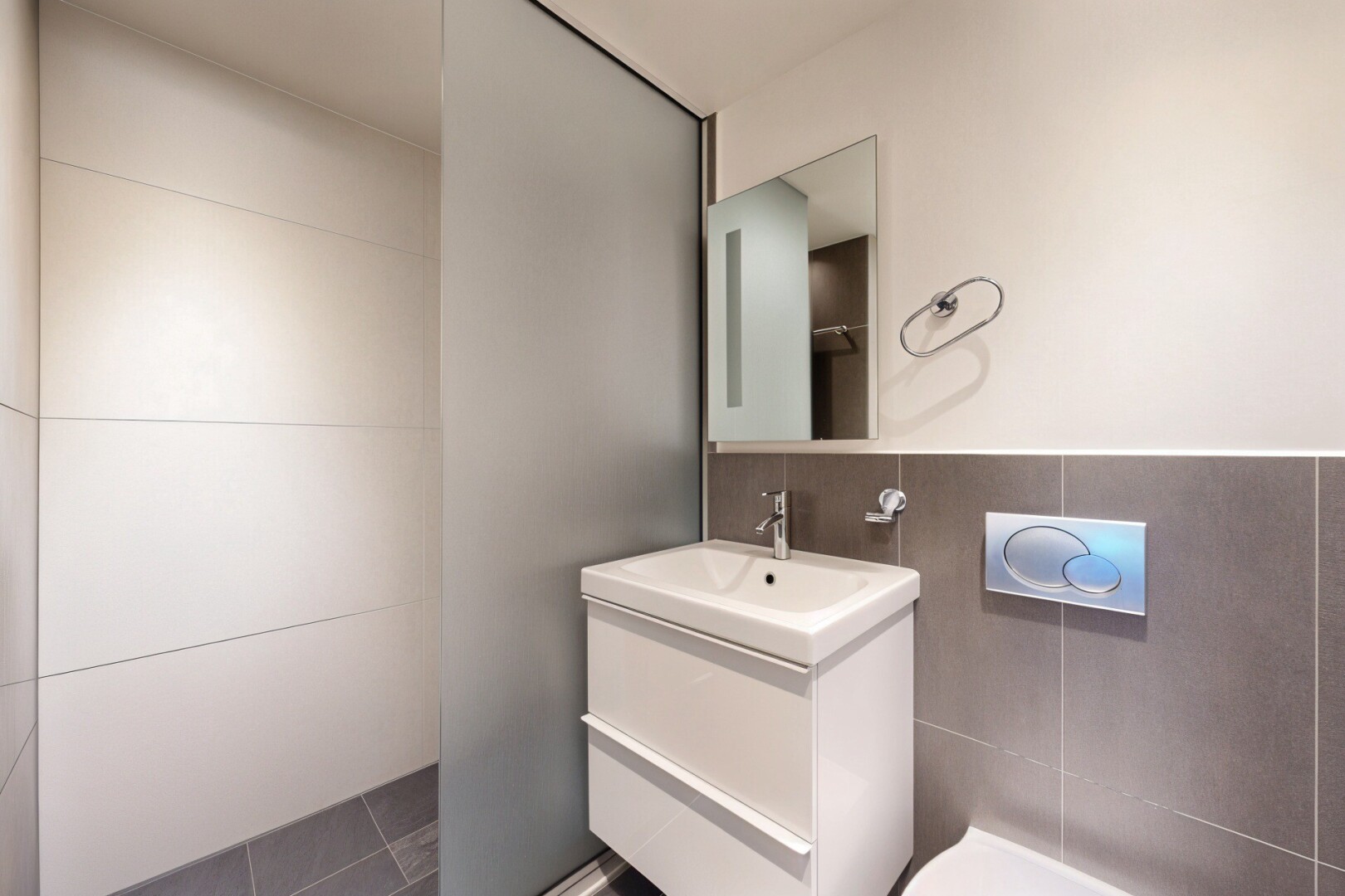 half bathroom with vanity and tile patterned floors