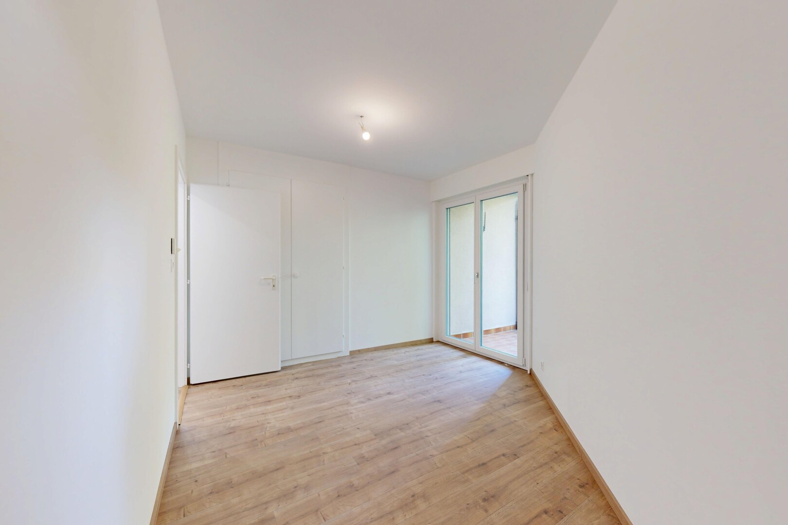spare room featuring light wood-style flooring and baseboards