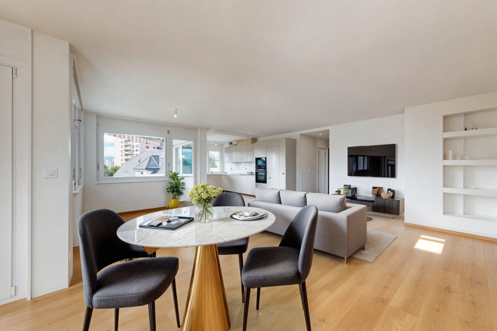 unfurnished room featuring built in shelves and light wood finished floors