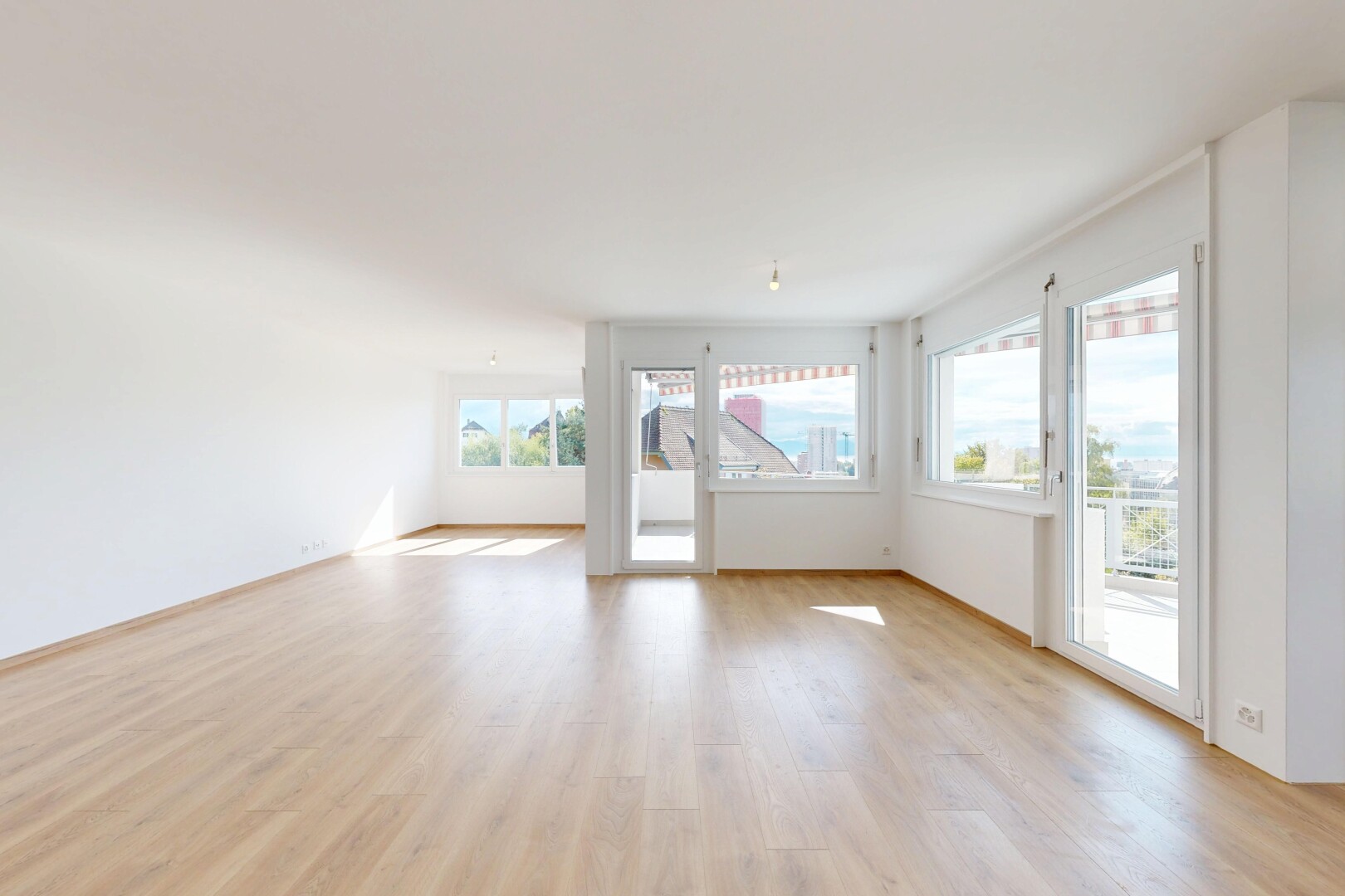 empty room with light wood-type flooring and baseboards