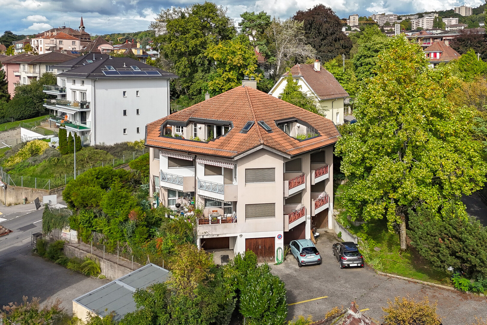 outdoor house with a chimney and uncovered parking