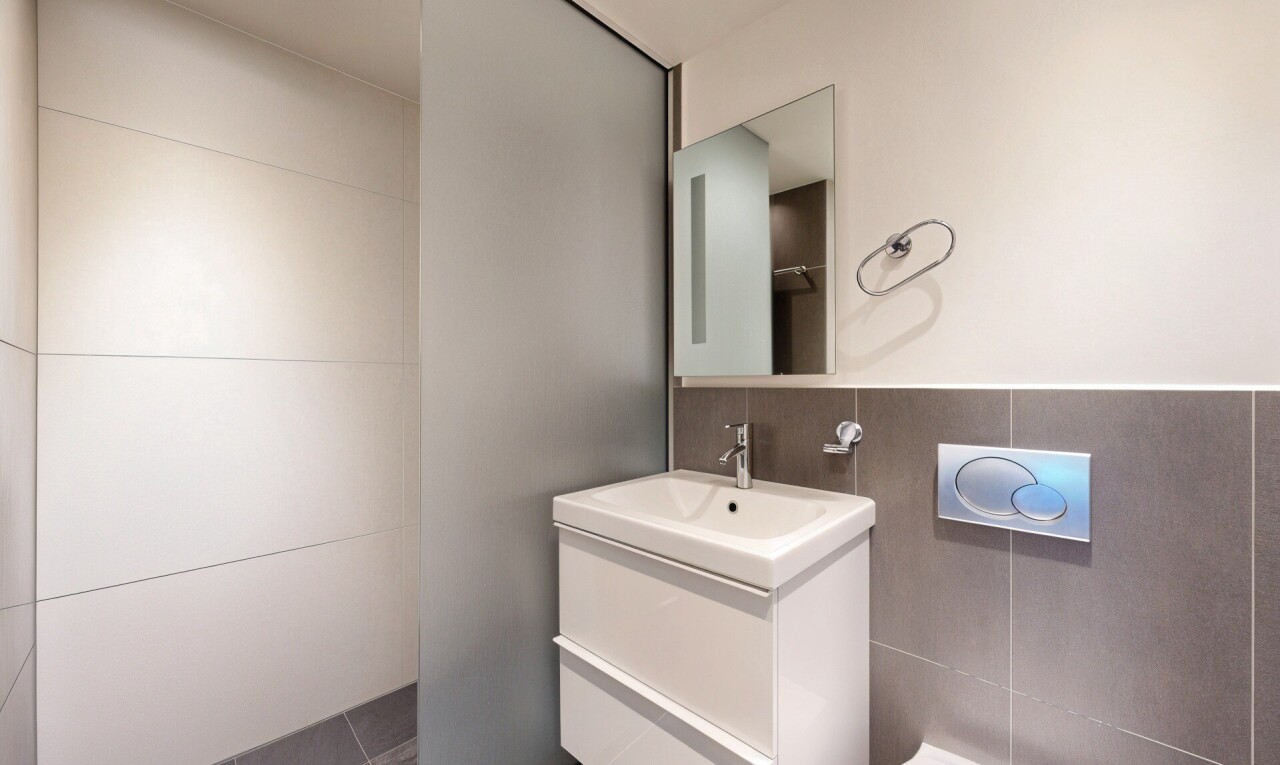 half bathroom with vanity and tile patterned floors