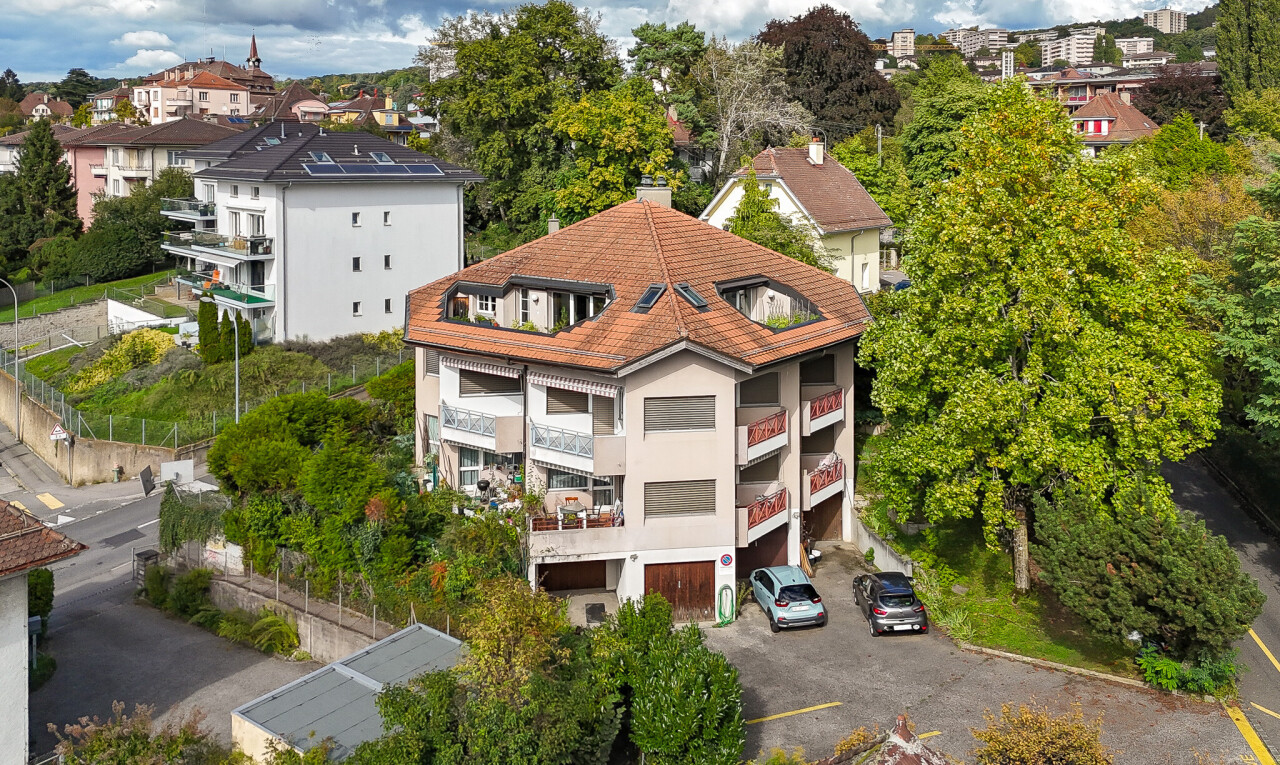 outdoor house with a chimney and uncovered parking