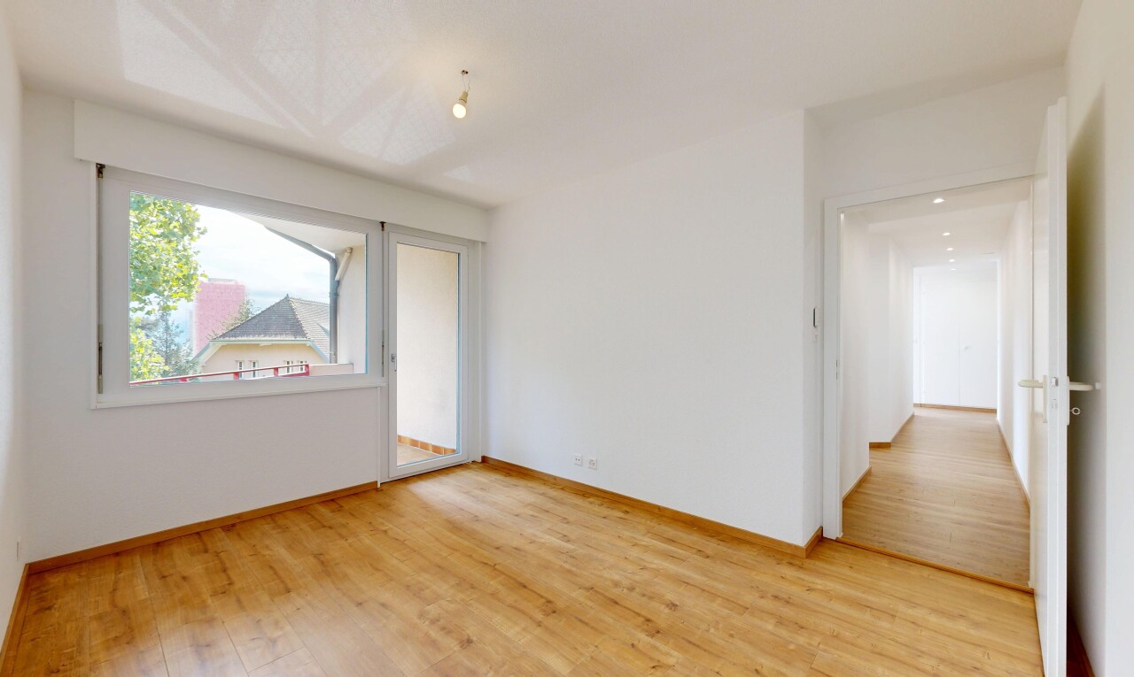 unfurnished room with light wood-style floors and baseboards