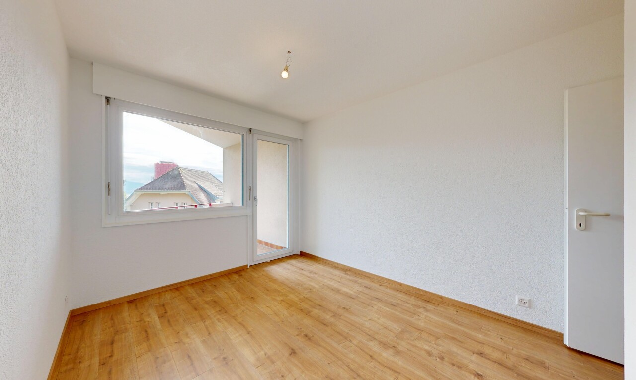 empty room with light wood finished floors and baseboards